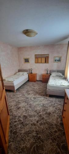 a large room with two beds and a carpet at Apartament Barbara in Ruda Śląska