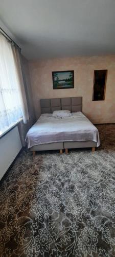 a bedroom with a bed and a large rug at Apartament Barbara in Ruda Śląska