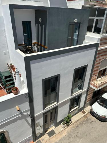 an aerial view of a white and black building at CASA LOPES in Olhão