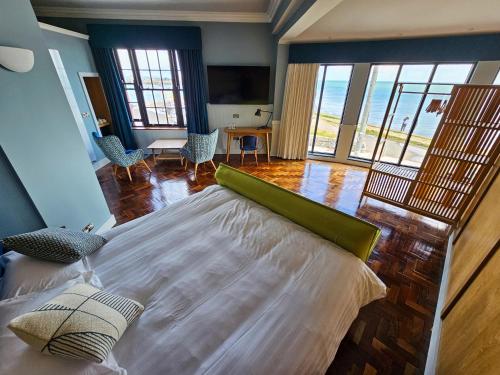 a bedroom with a large bed with a view of the ocean at King Sitric in Howth