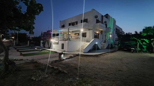 a large white house with stairs on the side of it at Afendra Hotel in Skiros