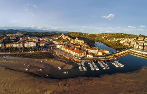an aerial view of a harbor with boats in the water at Hotel Faro de San Vicente in San Vicente de la Barquera