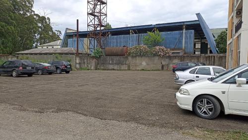 a parking lot with cars parked in front of a building at Apartment Zhemchuzhina Ureki-4 in Ureki