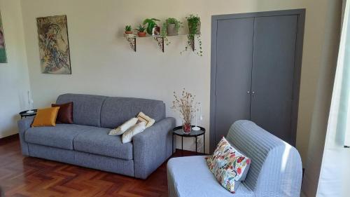 a living room with a couch and a chair at Quiet in Biancamano - Casa Vacanze Roma in Rome