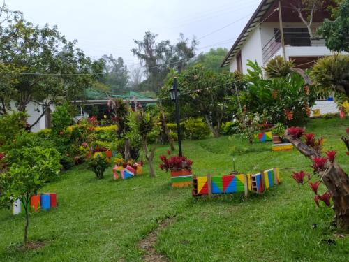 a yard with colorful flags in the grass at Cabaña Campestre Santa Helena in Choachí