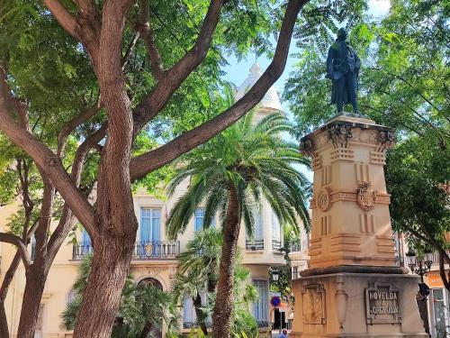 a statue in front of a building with trees at Apartamento Merlot 11 in Novelda