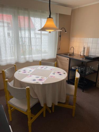 a kitchen with a table with a white table cloth on it at Endless Summer in Pärnu