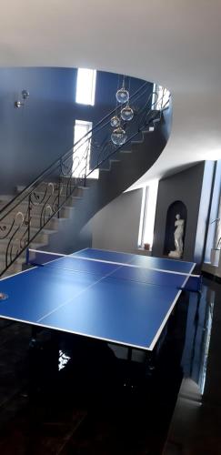a blue ping pong table in front of a staircase at Near Yerevan Serlinhouse in Oshakan