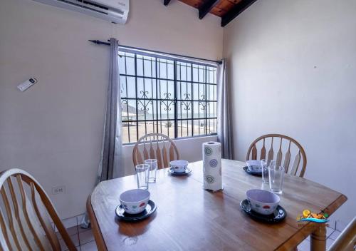 a dining room table with chairs and a window at Condo 3 Easy Walk to San Felipe Malecon in San Felipe