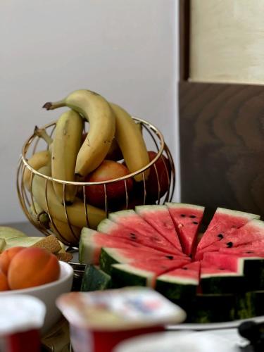 a basket of bananas and fruit on a table at Duka's Hotel in Ksamil