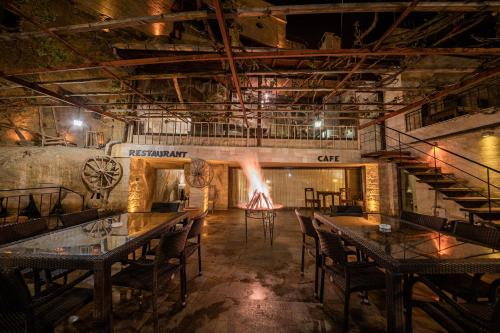 a room with tables and chairs and a stage at Konak Bezirhane Cave Otel in Urgup