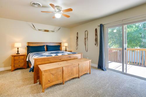 a bedroom with a bed with a ceiling fan and a window at Laramie Vacation Rental about 4 Mi to Downtown! in Laramie