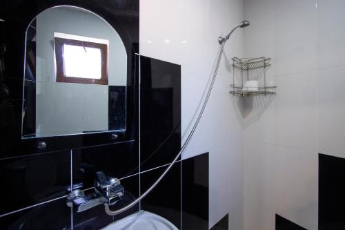 a bathroom with a sink and a mirror at Hotel Smile in K'obulet'i