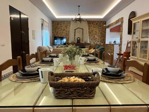a dining room table with a basket of food on it at La Estacada in Lora del Río