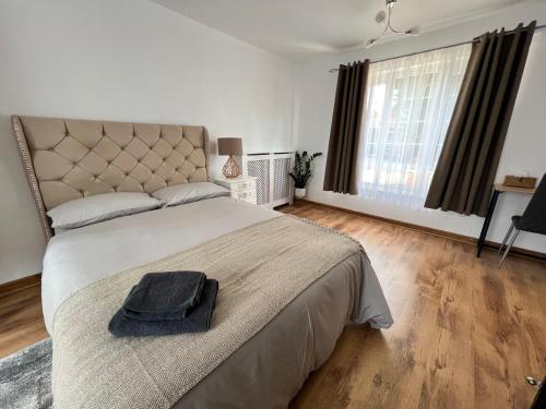 a bedroom with a bed with a hat on it at Large Room with free Netflix, Amazon Prime, Disney Plus in Bromley