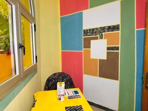 a room with a table with a yellow table cloth at Auberge Africa Thiossane in Saly Portudal