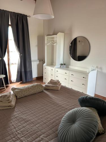 a bedroom with a large bed with a mirror and a dresser at Agriturismo cergallina in Vernasca
