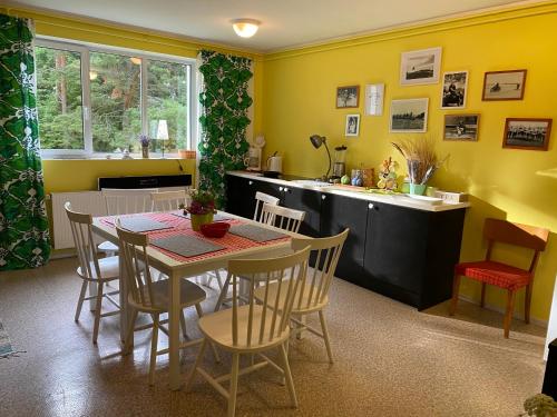 a kitchen and dining room with a table and chairs at Torgu Royal Guesthouse in Iide