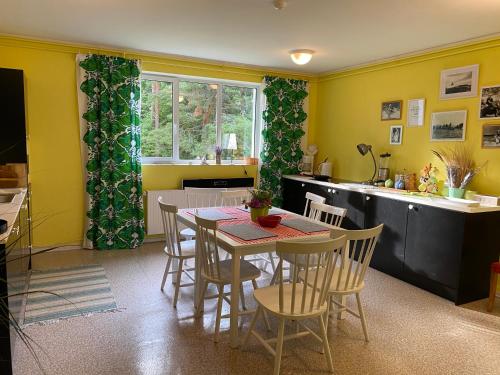 a kitchen and dining room with a table and chairs at Torgu Royal Guesthouse in Iide