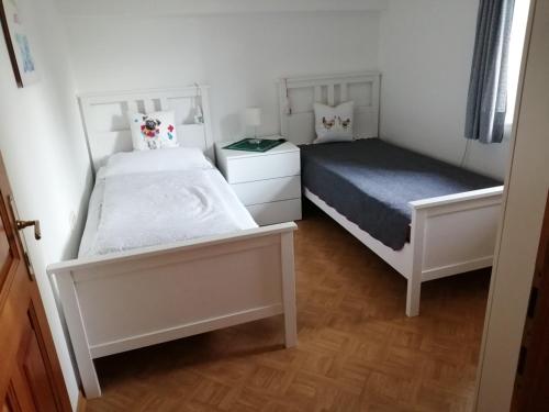 a bedroom with two beds and a bedskirts at Ferienwohnung Seilbahn in Sankt Gilgen