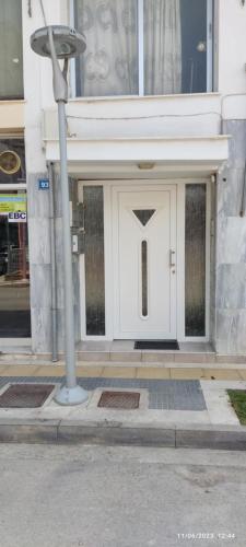 a white front door of a building at Aunt Vaso Sweet Home in Ptolemaida