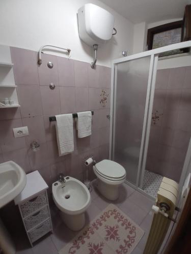 a bathroom with a shower and a toilet and a sink at Blasu Home in Maratea