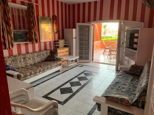 a living room with a couch and a television in it at Marina 2 chalet lake front in El Alamein