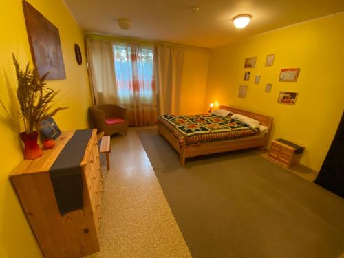 a bedroom with a bed and a chair in it at Torgu Royal Guesthouse in Iide