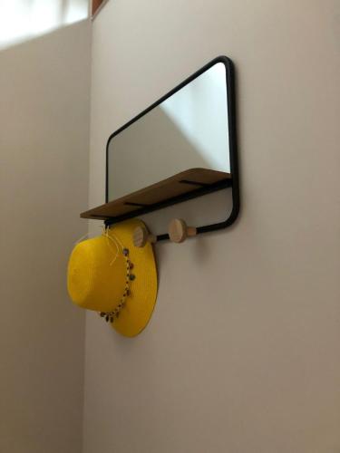a mirror and a lamp on a wall at La Casita de Pedraza in Segovia