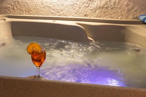 a bath tub with a glass of wine in it at Apartman Điran in Biograd na Moru