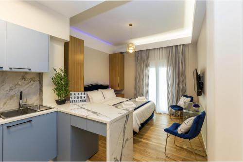 a kitchen and a bedroom with a bed in a room at Kookaki Athens City Stay by Raise in Athens