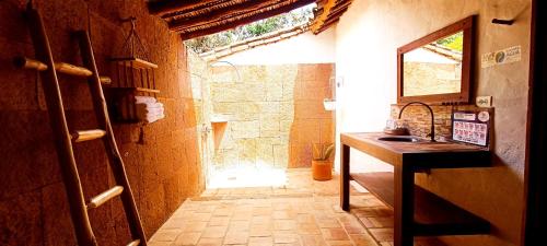 a bathroom with a sink and a mirror at Hotel Finca Buenos Aires Barichara in Barichara