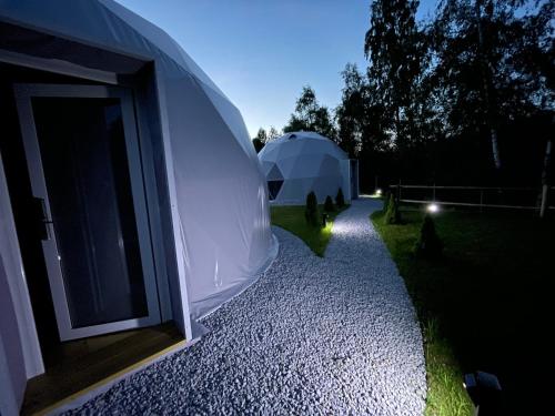 a large white dome tent in a yard at night at Poziom 713 in Trzebunia