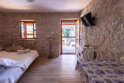 a bedroom with two beds and a tv on the wall at Apartman Điran in Biograd na Moru