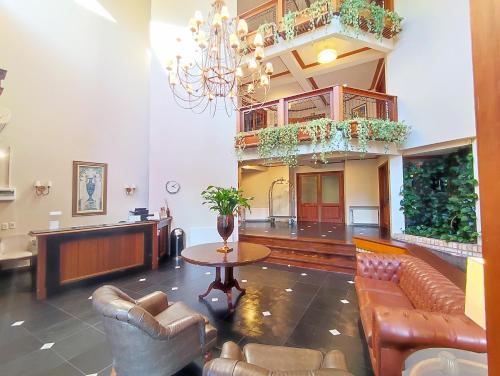 a lobby with couches and a table in a building at Suíte 455 Wish Resort Gramado in Gramado