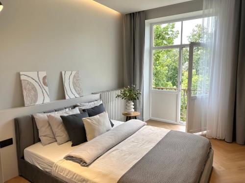 a bedroom with a large bed with a large window at Silver Apartment in Daugavpils