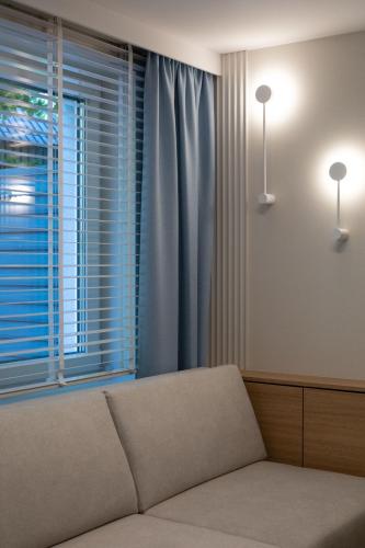 a living room with a couch and a window at Sileo Apart No.85 in Ustka