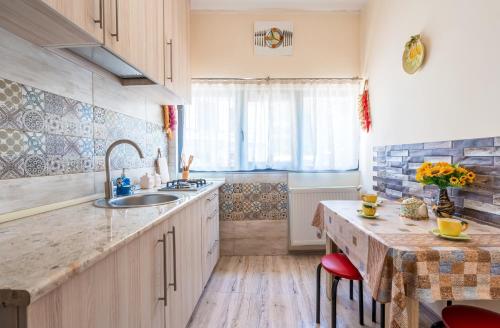 a kitchen with a sink and a table with chairs at Cozy House in Old Tbilisi in Tbilisi City