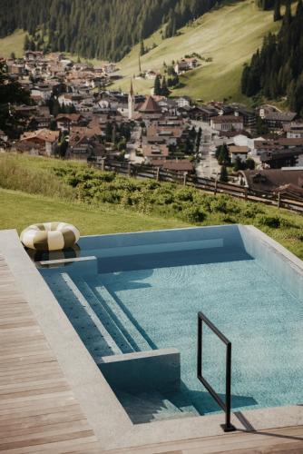 a swimming pool with a view of a city at Luxury Spa Chalet Lum d'Or in Selva di Val Gardena