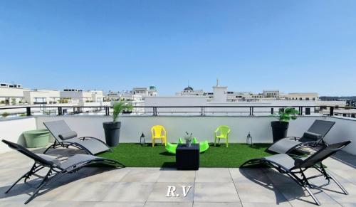 a patio with chairs and a table on a roof at ROOFTOP VILLA Disney - Val d'Europe in Chessy