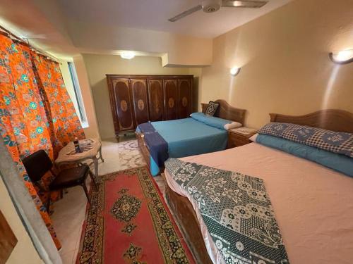 a small bedroom with two beds and a window at EL Fouly Villa with beach front فيلا لمة العيله الفولي - سيدي كرير in Abû Zeira