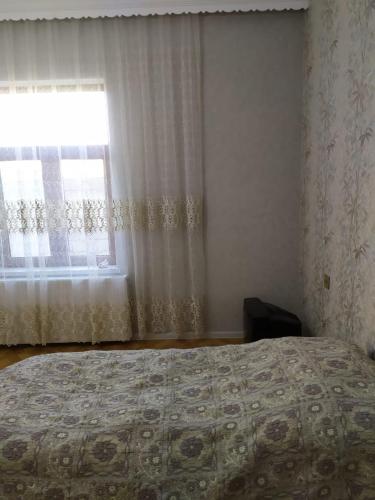 a bedroom with a bed and a window at Villa in Nakhchivan city, Azerbaijan in Naxçıvan