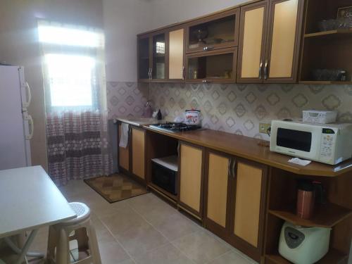 a kitchen with a microwave on a wooden counter at Villa in Nakhchivan city, Azerbaijan in Naxçıvan
