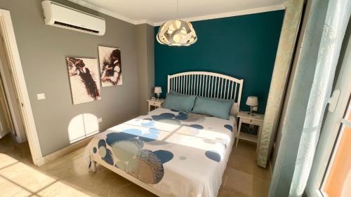 a bedroom with a bed and a green wall at Selena Luxury Monte Carrera in La Playa de Arguineguín