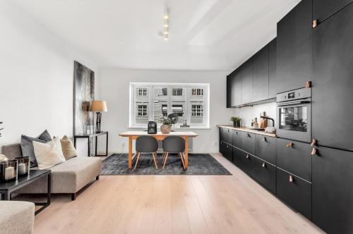 a kitchen and living room with a table and a couch at Apartment in the best part of Oslo in Oslo