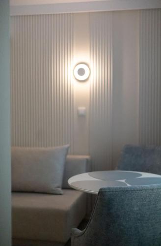 a room with a table and a chair and a light at Sileo Apart No.85 in Ustka