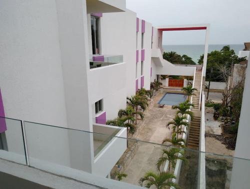 an external view of a building with palm trees and a swimming pool at An amazing stay in Progreso, close to everything in Progreso