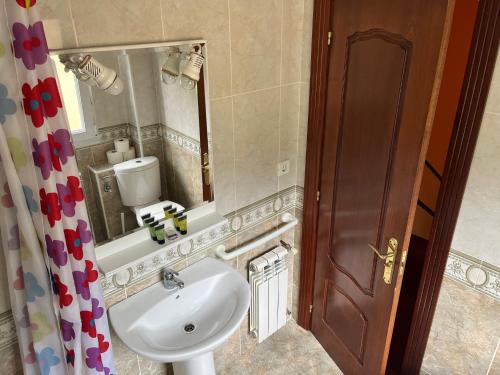 a bathroom with a sink and a mirror at Apartamentos La Reserva Isla Playa in Isla