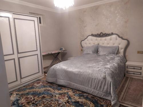 a bedroom with a large bed and a door at House in Nakhchivan city, Azerbaijan in Naxçıvan
