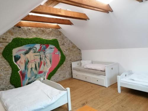 a bedroom with two beds and a wall mural at Chalupa u Manišov in Laskár